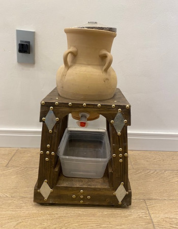 Pottery water pitcher with spout and decorative wood base Pottery water pitcher with spout and decorative wood base